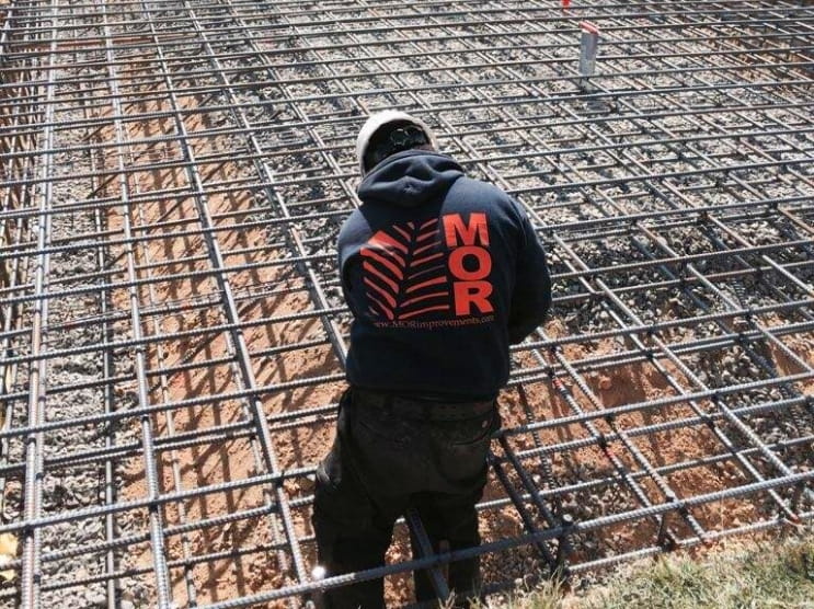 MOR Construction worker installing rebar reinforcement for a concrete foundation in Glen Mills, PA.